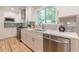 Bright kitchen with stainless appliances, white cabinets, subway tile backsplash and quartz countertops at 1748 Alvarado Sw Ter, Atlanta, GA 30310