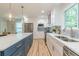 Bright kitchen features an island with marble countertop, stainless appliances, and hardwood floors at 1748 Alvarado Sw Ter, Atlanta, GA 30310