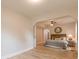 Bright main bedroom features a ceiling fan, wood floors, a decorative mirror and a king bed at 1748 Alvarado Sw Ter, Atlanta, GA 30310