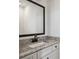 Modern bathroom featuring a granite countertop, a sink, and a black framed mirror at 310 Mcdonough Se Blvd # 101, Atlanta, GA 30315