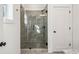 Glass enclosed shower with tile, next to a door and small window at 310 Mcdonough Se Blvd # 101, Atlanta, GA 30315