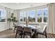 Dining room with views from large windows and neutral colored seating with a table that includes an elegant vase centerpiece at 310 Mcdonough Se Blvd # 101, Atlanta, GA 30315