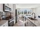 Kitchen with stainless steel appliances and an island that includes barstool seating connecting to a dining room at 310 Mcdonough Se Blvd # 101, Atlanta, GA 30315