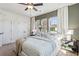 Bedroom featuring large windows, a ceiling fan, and neutral-toned furniture and decor at 310 Mcdonough Se Blvd # 101, Atlanta, GA 30315