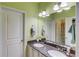 Well-lit bathroom features double sinks with granite countertop, and a neutral color scheme at 3538 Lily Magnolia Ct, Buford, GA 30519