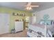 Bedroom with a green accent wall, white doors and a large, white dresser at 3538 Lily Magnolia Ct, Buford, GA 30519