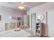 Cozy bedroom with white metal bed frame, light pink walls and a light fixture fan at 3538 Lily Magnolia Ct, Buford, GA 30519