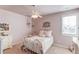 Bedroom with white iron bed frame, hanging plants and a white dresser at 3538 Lily Magnolia Ct, Buford, GA 30519