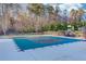 Outdoor pool covered for the off-season, surrounded by trees in a well-maintained community at 3538 Lily Magnolia Ct, Buford, GA 30519