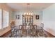 Elegant dining room with a stylish chandelier, china cabinet, and seating for six at 3538 Lily Magnolia Ct, Buford, GA 30519