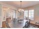 Formal dining room with an elegant chandelier and large windows at 3538 Lily Magnolia Ct, Buford, GA 30519