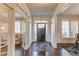 Inviting entryway showcasing hardwood floors, bright white trim, and a charming foyer rug at 3538 Lily Magnolia Ct, Buford, GA 30519