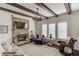 Comfortable living room with stone fireplace, beamed ceiling, and lots of natural light at 3538 Lily Magnolia Ct, Buford, GA 30519