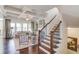 Living room featuring hardwood floors, large windows, and coffered ceilings at 3538 Lily Magnolia Ct, Buford, GA 30519