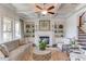 Bright living room with a fireplace, built-in shelves, coffered ceilings, and staircase at 3538 Lily Magnolia Ct, Buford, GA 30519