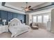 Spacious main bedroom features a decorative tray ceiling, accent wall, and ample natural light at 3538 Lily Magnolia Ct, Buford, GA 30519