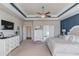 Main bedroom showing the ensuite bathroom, tv, and decorative trim at 3538 Lily Magnolia Ct, Buford, GA 30519