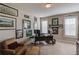 Well-lit home office with desk, chair, and numerous wall decorations at 3538 Lily Magnolia Ct, Buford, GA 30519