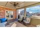 Covered back porch featuring comfortable seating, brick siding, and a ceiling fan at 3538 Lily Magnolia Ct, Buford, GA 30519