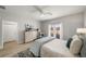 Cozy bedroom with neutral walls, wood floor, ceiling fan, and balcony access at 5229 Noble Village Way, Lilburn, GA 30047