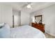 Bright bedroom features a wooden dresser, ceiling fan, and light hardwood floors at 5229 Noble Village Way, Lilburn, GA 30047