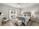 Cozy bedroom with a wrought iron bed frame, area rug, and French doors leading to the exterior at 5229 Noble Village Way, Lilburn, GA 30047