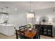 Dining area with a rustic wood table, stylish lighting, and decorative buffet cabinet at 5229 Noble Village Way, Lilburn, GA 30047