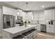 Modern kitchen featuring white cabinets, an island with stools, and stainless steel appliances at 5229 Noble Village Way, Lilburn, GA 30047