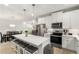 Bright kitchen with stainless appliances, white cabinetry, and an island with barstool seating at 5229 Noble Village Way, Lilburn, GA 30047