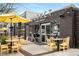 Outdoor seating area at a restaurant with a yellow umbrella at 5229 Noble Village Way, Lilburn, GA 30047