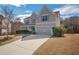 Charming two-story home with a well-manicured lawn and a two-car garage at 690 Floral Pl, Suwanee, GA 30024