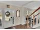 Welcoming foyer with hardwood floors, staircase, and ample natural light from the front door and windows at 690 Floral Pl, Suwanee, GA 30024