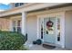 Elegant front door with a floral wreath, decorative columns, and sidelight windows at 690 Floral Pl, Suwanee, GA 30024