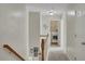 Upstairs hallway leading to laundry room with washer and dryer and carpeted floors at 690 Floral Pl, Suwanee, GA 30024