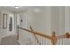 Second floor hallway with white trim and natural light flowing through multiple doorways at 690 Floral Pl, Suwanee, GA 30024