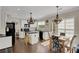 Well-lit kitchen with granite counters, stainless appliances, and an island with breakfast bar seating at 690 Floral Pl, Suwanee, GA 30024