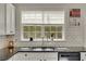 Kitchen showcases a garden window, stainless steel appliances, granite countertops, and white subway tile backsplash at 690 Floral Pl, Suwanee, GA 30024