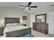 Spacious main bedroom with vaulted ceiling, ceiling fan, and wooden furniture at 690 Floral Pl, Suwanee, GA 30024