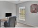 Home office with a desk, ergonomic chair and window for natural light at 690 Floral Pl, Suwanee, GA 30024