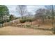 Landscaped backyard with retaining wall and a spacious grass area at 916 Santa Anita Dr, Woodstock, GA 30189