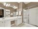 Bathroom featuring double sinks with white cabinets and a glass-enclosed shower at 916 Santa Anita Dr, Woodstock, GA 30189