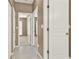 Hallway with tile flooring, neutral paint, and white doors at 916 Santa Anita Dr, Woodstock, GA 30189