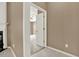 Hallway view into a room with a tray ceiling and a fan, providing an open view of the space at 916 Santa Anita Dr, Woodstock, GA 30189