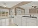 The bright kitchen showcases ample natural light and stainless sink, seamlessly connecting to the living area at 916 Santa Anita Dr, Woodstock, GA 30189