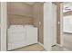 Laundry room with white washer and dryer and access to additional rooms at 916 Santa Anita Dr, Woodstock, GA 30189