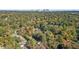 An aerial shot of a neighborhood with green trees and a city skyline in the background at 1270 Graymont Sw Dr, Atlanta, GA 30310