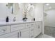 Bathroom vanity featuring double sinks, modern fixtures, and lots of storage in white cabinets at 1270 Graymont Sw Dr, Atlanta, GA 30310