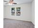 Bedroom features neutral walls, carpet, a ceiling fan, and windows overlooking the exterior at 1270 Graymont Sw Dr, Atlanta, GA 30310