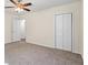 Bedroom with neutral carpet, ceiling fan, closet, and door to hallway at 1270 Graymont Sw Dr, Atlanta, GA 30310