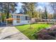 This renovated home features a lush lawn, a covered outdoor patio, and new landscaping at 1270 Graymont Sw Dr, Atlanta, GA 30310